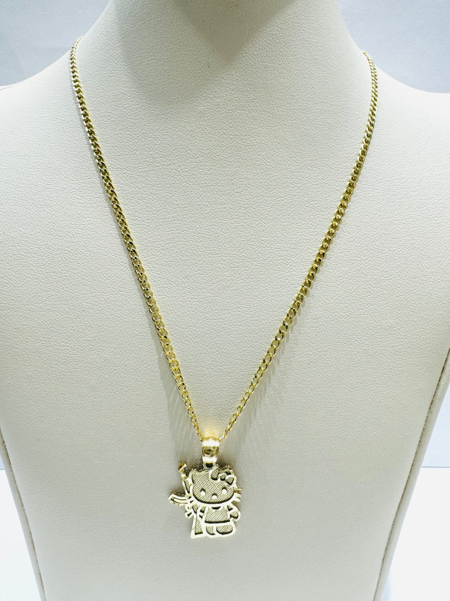 10K GOLD CUBAN LINK NECKLACE 18”, WEIGHT: 1.3gm, WIDTH: 1.99mm WITH SMALL HELLO KITTY GUN PENDANT, WEIGHT: 1.8gm