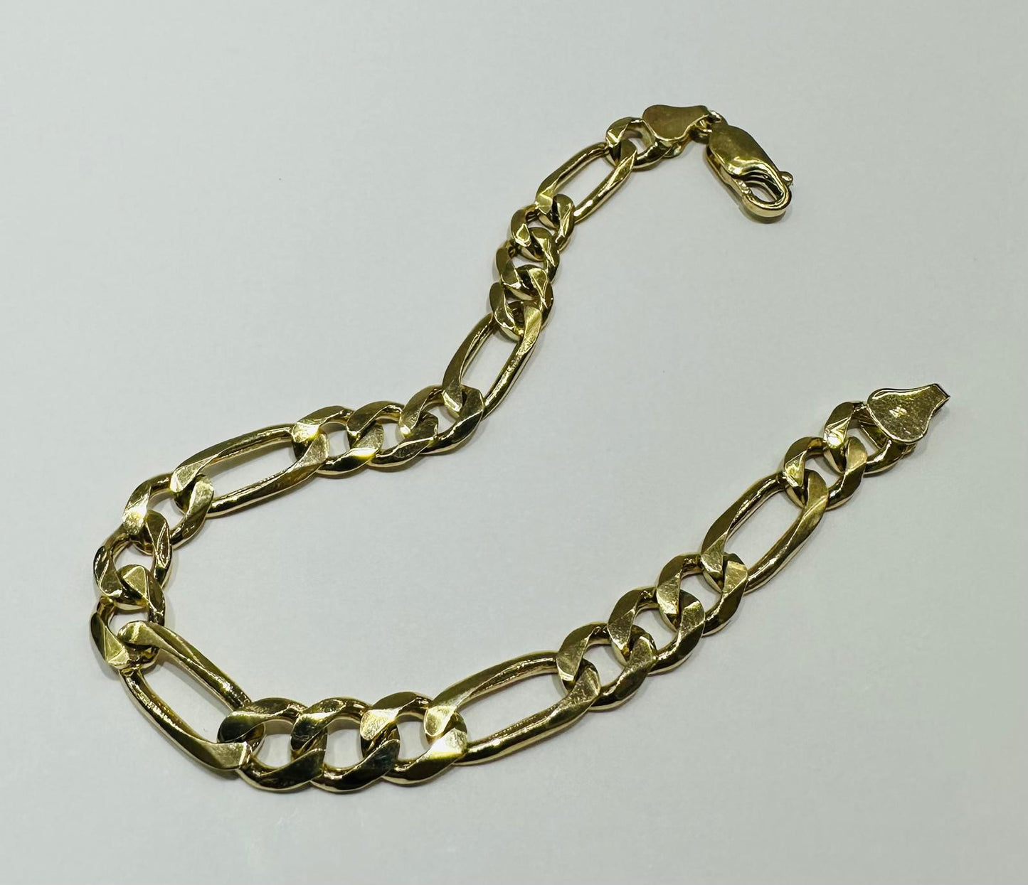 10K GOLD FIGARO LINK CHAIN BRACELET-  12.8gm    7"     6.45mm