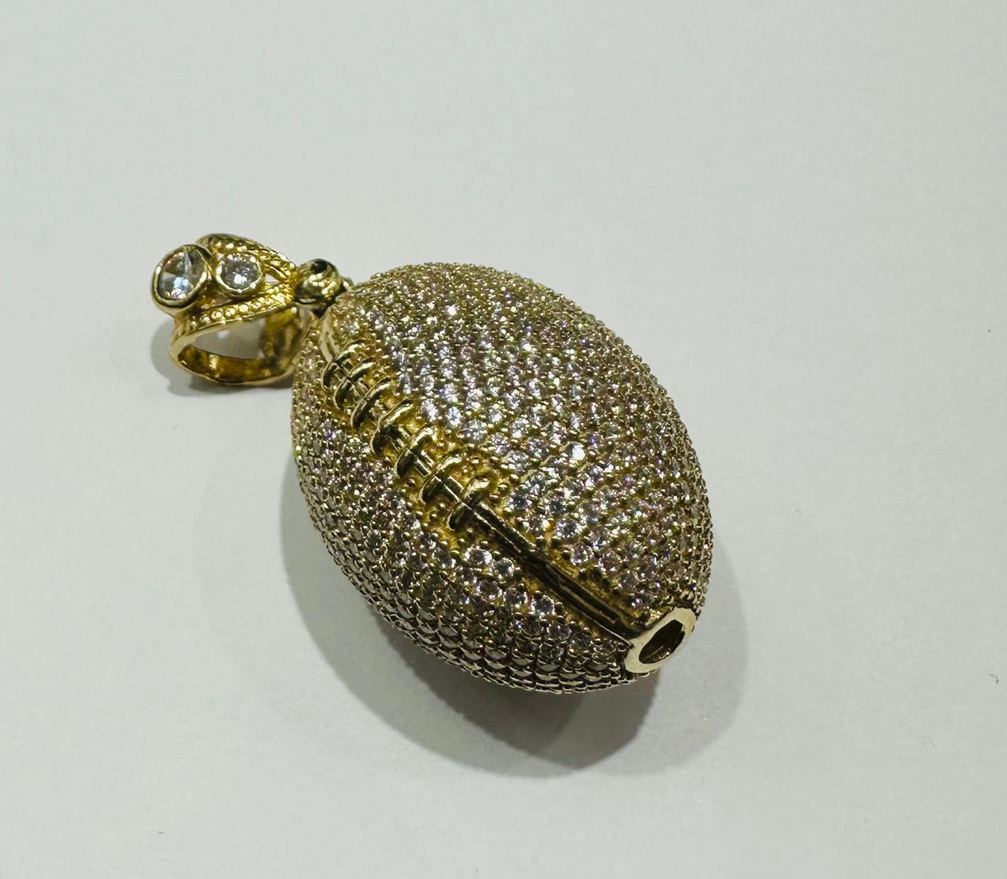 10K GOLD FOOTBALL PENDANT WITH WHITE SAPPHIRE-  WEIGHT: 15.3gm